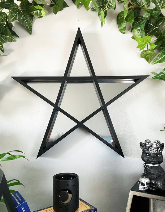Pictured is a mirror shaped like a pentagram.
