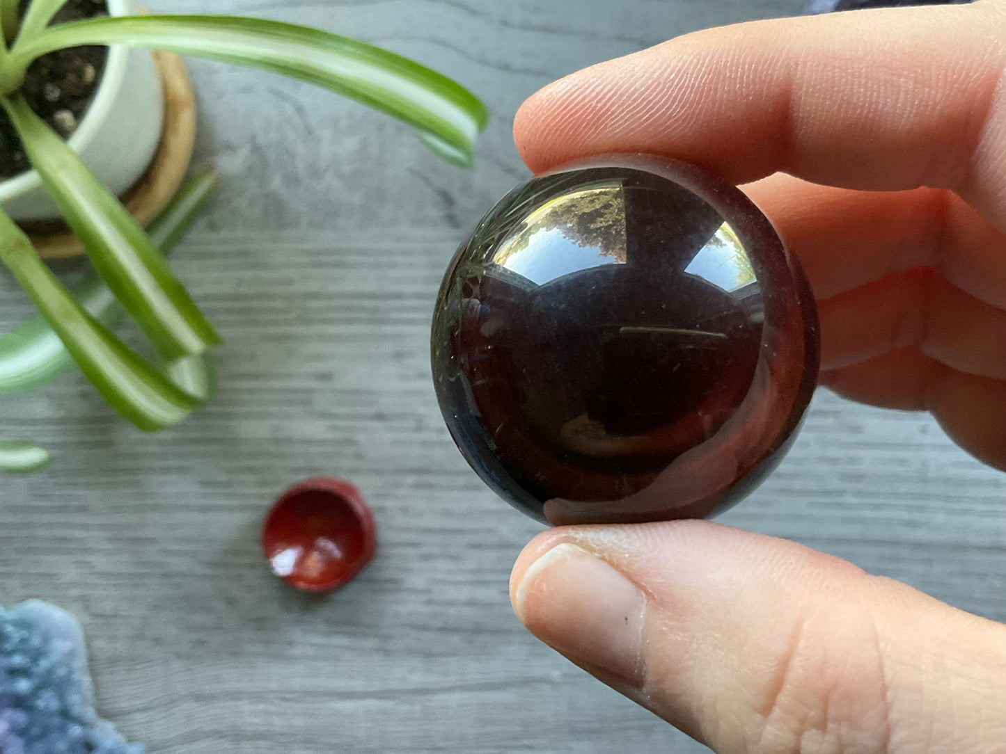 Pictured is a sphere carved out of red tiger's eye.
