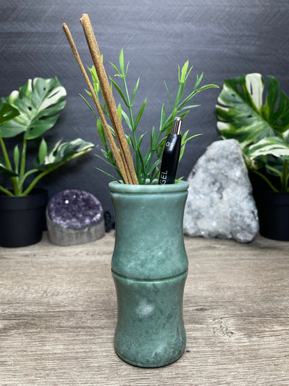 Pictured is a bamboo-shaped vase carved out of Lushan jade.