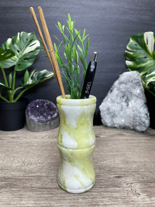 Pictured is a bamboo-shaped vase carved out of serpentine.