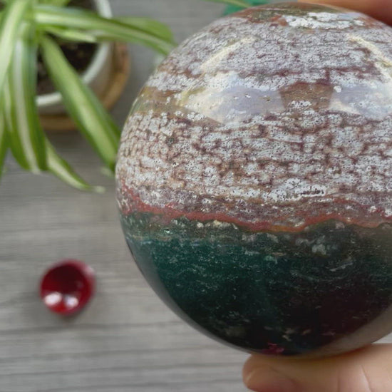 Pictured is a sphere carved out of ocean jasper / river jasper.