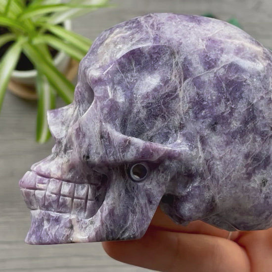 Pictured is a large skull carved out of lepidolite.