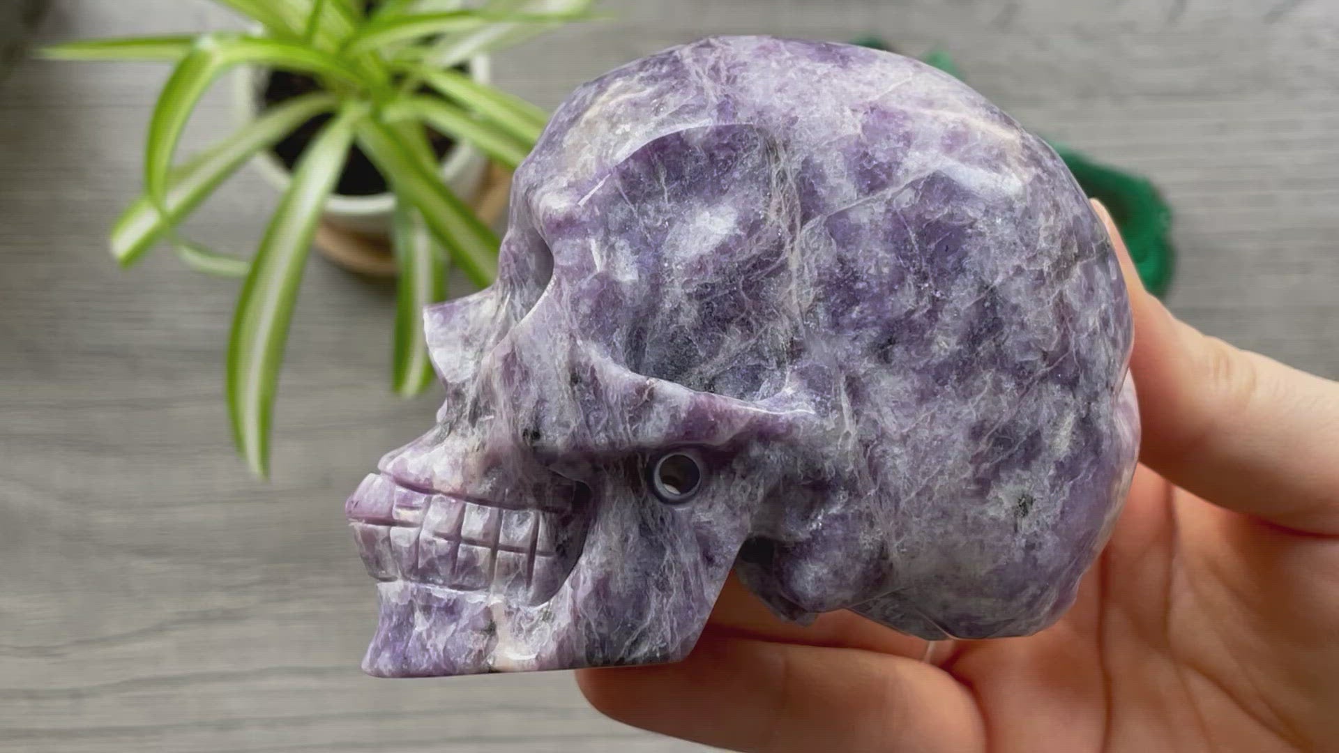Pictured is a large skull carved out of lepidolite.