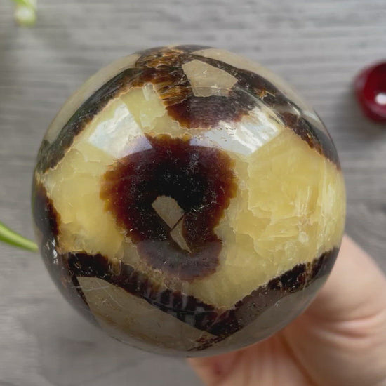 Pictured is a sphere carved out of septarian.