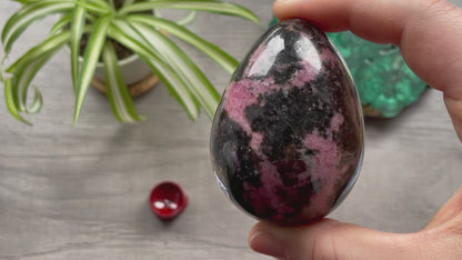 Pictured is a rhodonite egg.